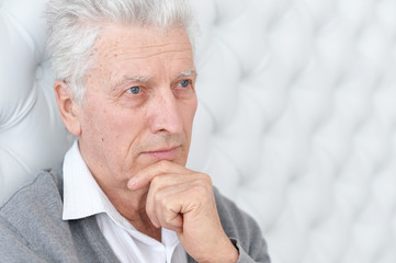 Close up portrait of thoughtful senior man posing