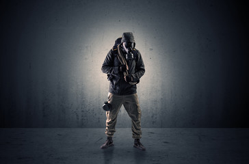 Bad agent in a dark room with arms on his hand and gas mask
