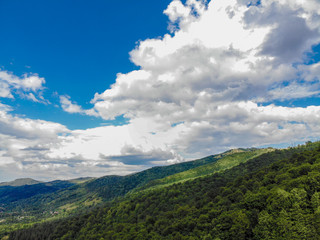 mountain hills and forest on the background of blue sky in the Carpathians, Ukraine
