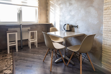 A table with chairs in the interior of the kitchen