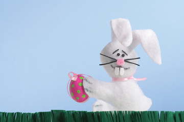 Easter bunny holding a decorated egg
