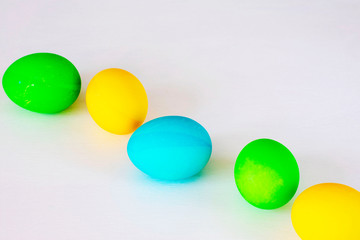 Easter eggs multicolored isolated on white background. Minimal easter concept. Happy easter card with copy space for text. Top view, flat.