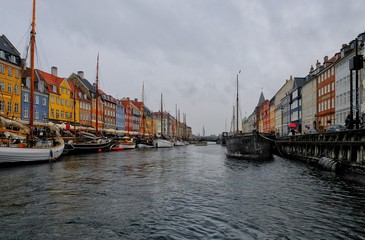 Fototapeta premium Panorama of north side of Nyhavn with colorful facades of old houses and old ships in the Old Town of Copenhagen, capital of Denmark.