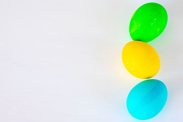 Easter eggs multicolored isolated on white background. Minimal easter concept. Happy easter card with copy space for text. Top view, flat.