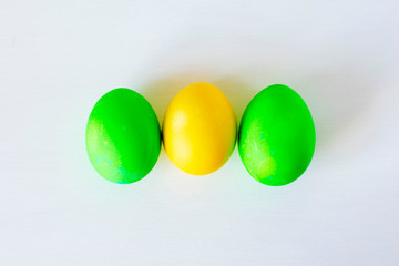 Easter eggs multicolored isolated on white background. Minimal easter concept. Happy easter card with copy space for text. Top view, flat.