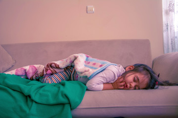 3 year old little girl sleeping on sofa