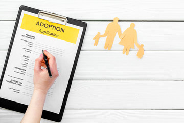 Adoption application near family figures on white background top view copyspace