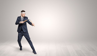 Obraz premium Young businessman in suit fighting in an empty space 