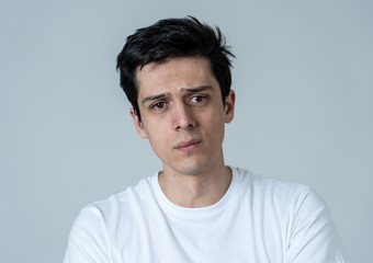 Portrait of sad and depressed man. Isolated on neutral background. Human expressions and emotions
