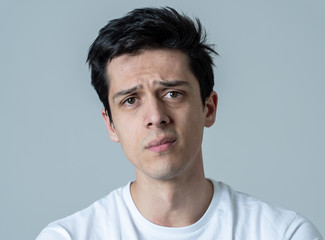 Obraz premium Portrait of sad and depressed man. Isolated on neutral background. Human expressions and emotions