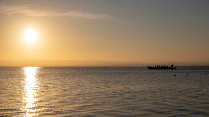 Boat with people in Albufera of Valencia at sunset.