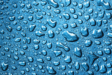 Water drops wet surface background. Blue color rain dew texture.