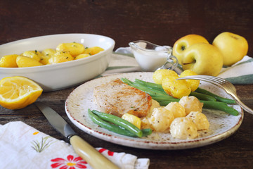 French cuisine: fried pork with Norman apple sauce, green beans and fried potatoes