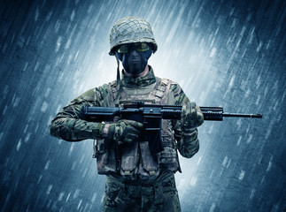 Armed soldier standing in rainy weather
