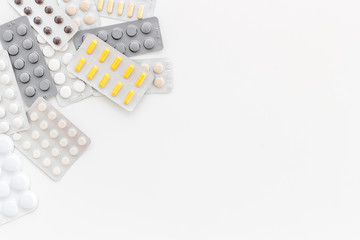 Medicine help with drugs on work desk of doctor white background top view mock up