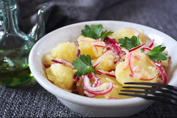 Rustic country potato salad with red onions, olive oil and herbs