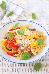Italian cuisine. Neapolitan pasta. Farfalle with mushrooms and belle pepper and cheese
