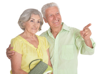 Portrait of a happy senior couple pointing to the right 