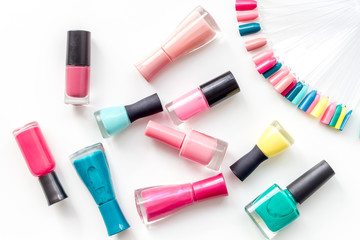 Obraz premium cosmetics for manicure with nail polish and palette for spring nail design in nail bar on white background top view