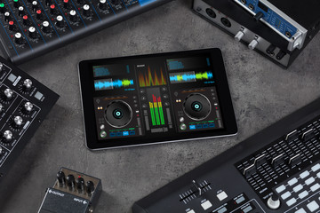 Mixing music on tablet with electronic music instruments concept
