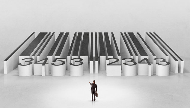 Young businessman standing in front of a big codebar
