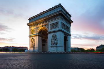 Fototapeta na wymiar Paris street during sunrise with the Arc de Triomphe in Paris, France.