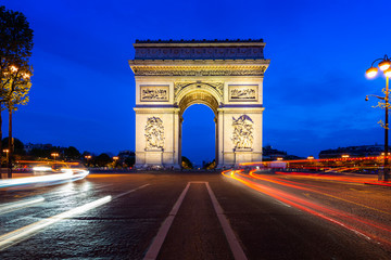 Fototapeta na wymiar Paris street at night with the Arc de Triomphe in Paris, France.