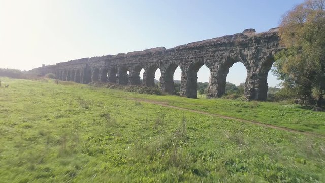 Aerial view of famous ancient roman aqueduct claudio landmark in parco degli acquedotti in rome drone slow motion dolly