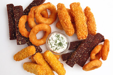 a dish for beer with a different snack on a wooden table