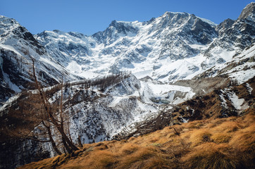 Mountain hiking path trough the massif of the Monte Rosa (Piedmont, Italy) to the Sella refuge, walked at the end of winter, with a full view of the glaciers