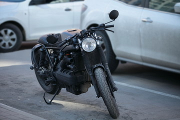 black motorcycle in the parking after driving in traffic jams in the city