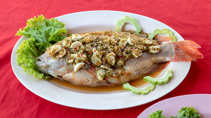 Tilapia fish steamed with garlic chili paste.