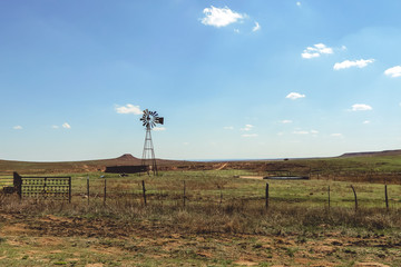 Fototapeta na wymiar Old windmill on a farm on a farm in the prairie