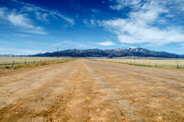 Dirt road leading up towards the Rocky Mountains