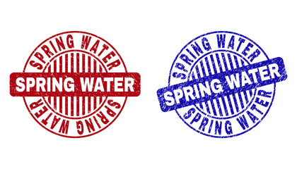 Grunge SPRING WATER round stamp seals isolated on a white background. Round seals with grunge texture in red and blue colors.