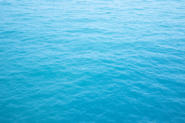 Blue Sea surface aerial view with waves from a drone, empty blank to background. soft focus.