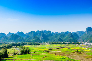 Countryside and mountain scenery with blue sky background 