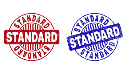 Grunge STANDARD round stamp seals isolated on a white background. Round seals with grunge texture in red and blue colors. Vector rubber imprint of STANDARD text inside circle form with stripes.
