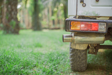 Close-up background view of car exhausts, adapted for use, blurred by sunlight and use, used in agriculture or in rubber plantations, oil palm