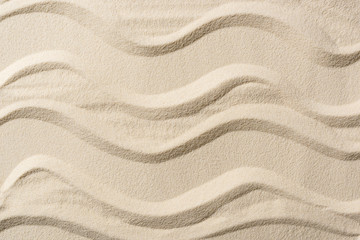 Fototapeta na wymiar top view of textured background with sand and smooth lines