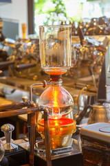 Fototapeta na wymiar Siphon (Syphon) coffee maker is a vacuum coffee maker brews coffee using two chambers where vapor pressure and vacuum produce coffee.