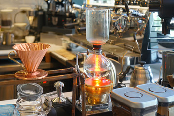Fototapeta na wymiar Siphon (Syphon) coffee maker is a vacuum coffee maker brews coffee using two chambers where vapor pressure and vacuum produce coffee.