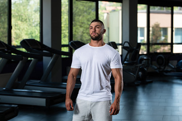 Fototapeta na wymiar Muscular Man Posing In White T-shirt
