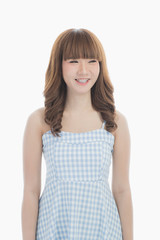 Front view close-up portrait of young beautiful Asian woman with curly long dark brown hair in light blue checked dress stand up straight  isolated white background