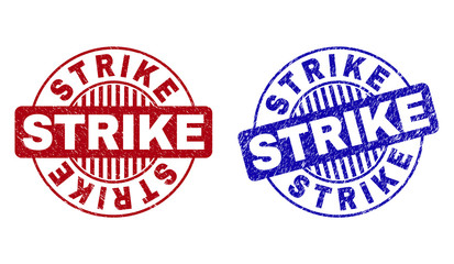 Grunge STRIKE round stamp seals isolated on a white background. Round seals with grunge texture in red and blue colors. Vector rubber watermark of STRIKE caption inside circle form with stripes.