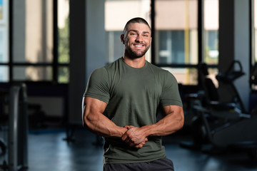 Fototapeta na wymiar Muscular Man Posing In Green T-shirt