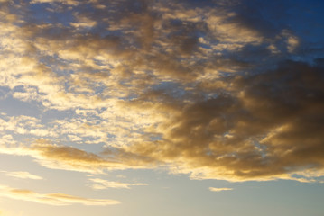 Fototapeta premium Blue sky with cotton clouds at sunset