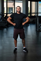 Fototapeta na wymiar Muscular Man Posing In Black T-shirt