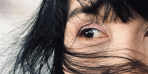 Fototapeta premium The image of a woman's eye is looking to the side. The conceptual beauty makeup