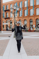 Woman walking across a city square